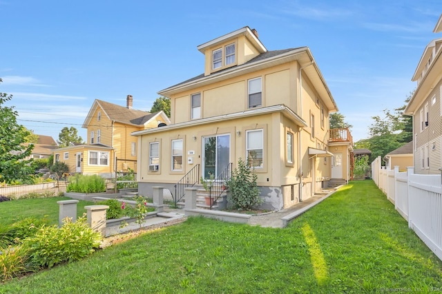 back of house featuring a lawn