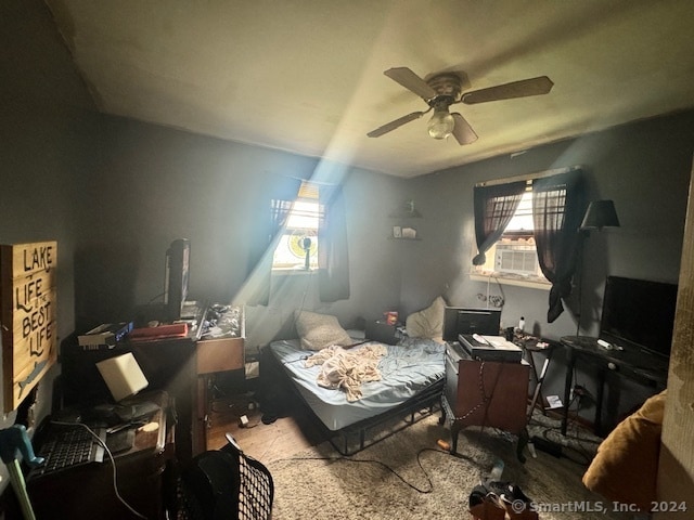 bedroom with cooling unit and ceiling fan