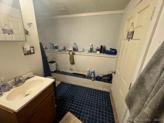 bathroom with vanity and ornamental molding