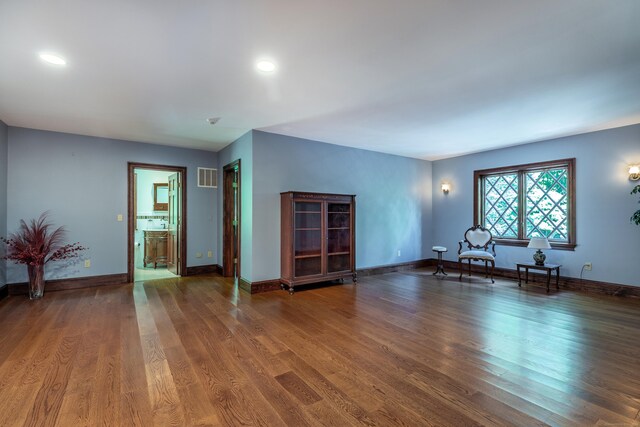 unfurnished living room with dark wood-type flooring