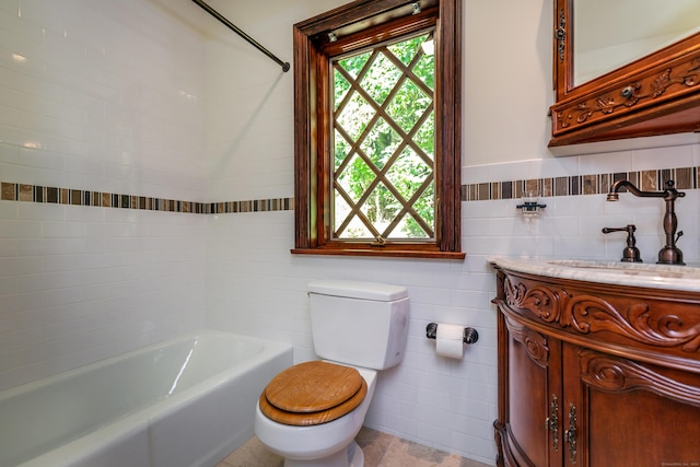 bathroom featuring a healthy amount of sunlight, tile walls, toilet, and a tub