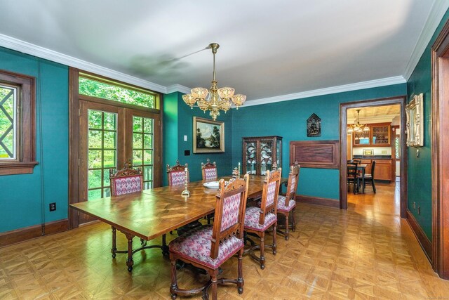 dining space with a notable chandelier, ornamental molding, french doors, and light parquet flooring