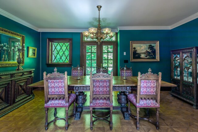 dining space with parquet floors, ornamental molding, a chandelier, and french doors