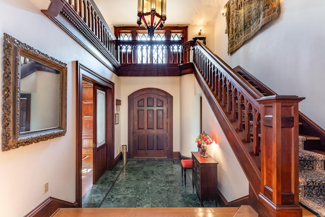 foyer entrance with a towering ceiling