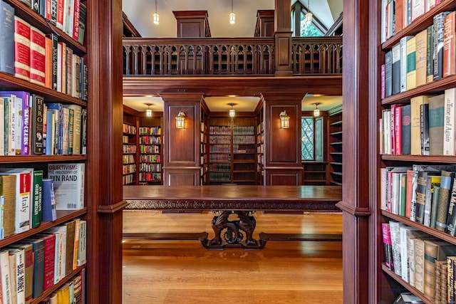 living area with bookshelves and a towering ceiling