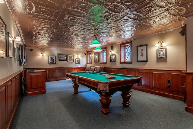 recreation room featuring carpet flooring, wainscoting, an ornate ceiling, and crown molding