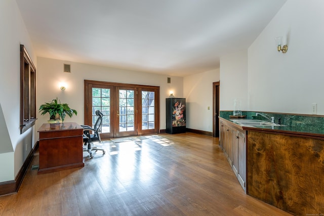 kitchen with sink and light hardwood / wood-style flooring