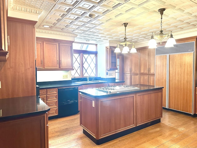 kitchen with a sink, an ornate ceiling, dark countertops, paneled built in refrigerator, and white gas stovetop