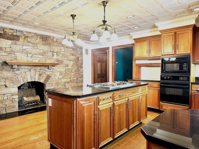 kitchen featuring dark countertops, an ornate ceiling, black appliances, and crown molding