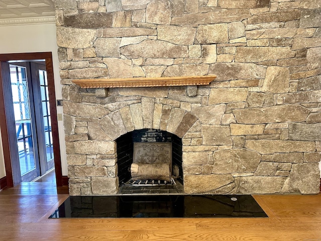 details with a fireplace, wood finished floors, and ornamental molding