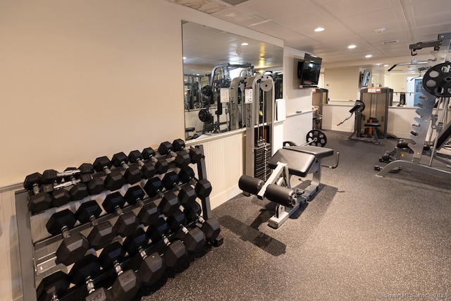 gym with carpet and a paneled ceiling