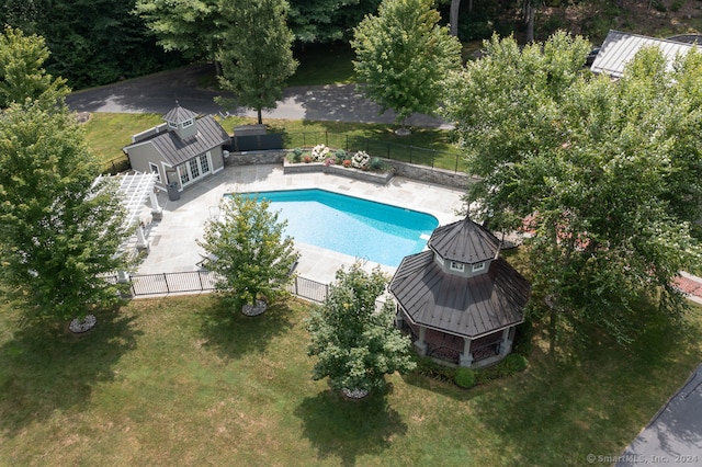 view of pool with a yard