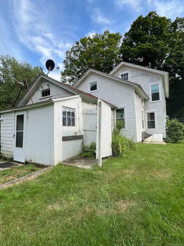 rear view of house with a lawn