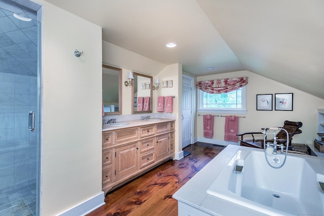 bathroom featuring hardwood / wood-style flooring, vanity, separate shower and tub, and vaulted ceiling