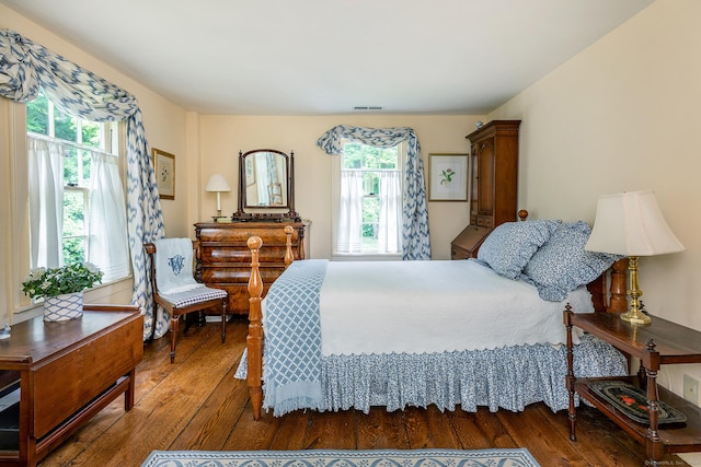 bedroom featuring dark wood-type flooring and multiple windows