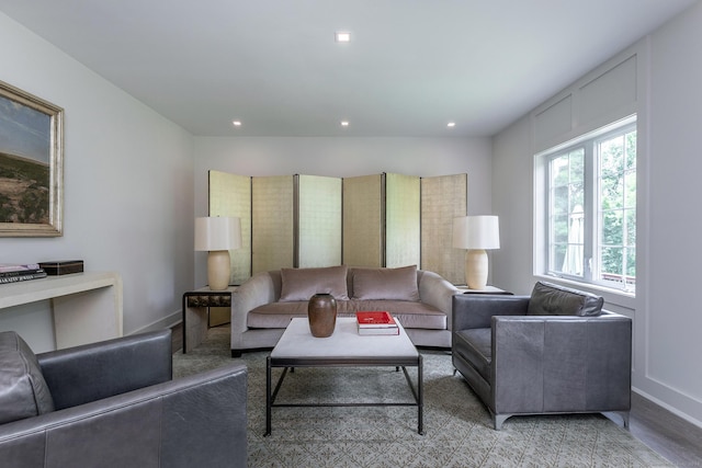 living room featuring recessed lighting, baseboards, and light wood finished floors