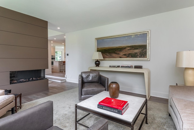 living room featuring recessed lighting, baseboards, and wood finished floors