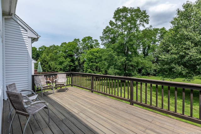 wooden terrace with a yard