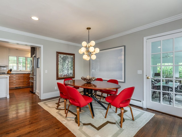 dining space featuring baseboards, dark wood finished floors, a baseboard radiator, crown molding, and a notable chandelier