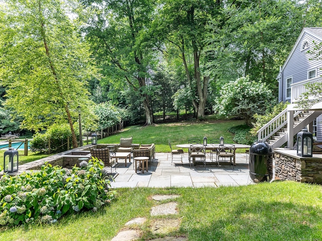 view of yard featuring stairway and a patio area