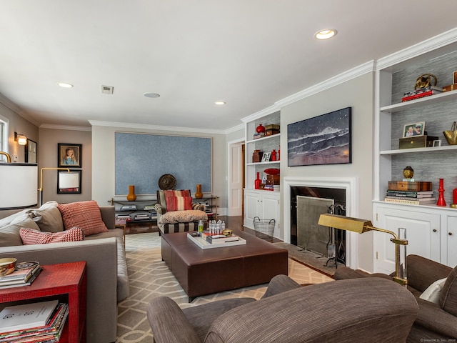 living room featuring visible vents, built in features, crown molding, a fireplace, and recessed lighting