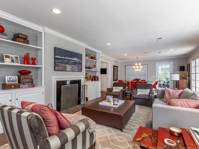 living room with visible vents, ornamental molding, a fireplace with flush hearth, and built in shelves