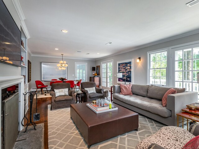 living room with recessed lighting, a fireplace, wood finished floors, visible vents, and ornamental molding