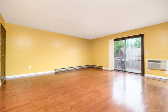 empty room featuring baseboards, a wall mounted air conditioner, a baseboard radiator, and light wood-style floors