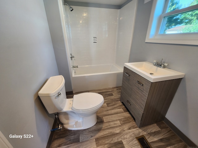 full bathroom featuring tiled shower / bath, toilet, and vanity