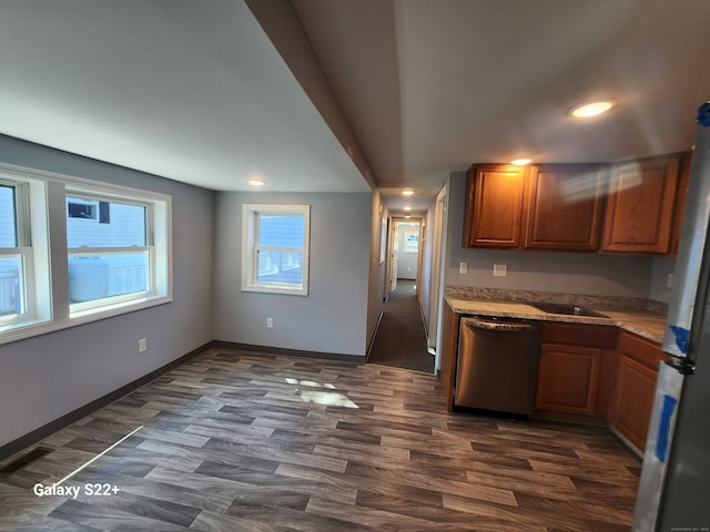 kitchen with appliances with stainless steel finishes and dark hardwood / wood-style floors