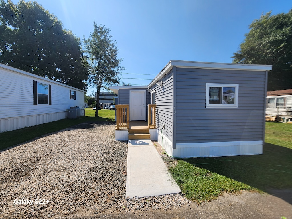 view of outbuilding featuring a lawn