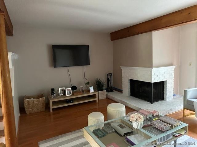 living room with hardwood / wood-style floors and a fireplace