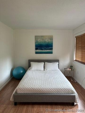 bedroom with hardwood / wood-style flooring