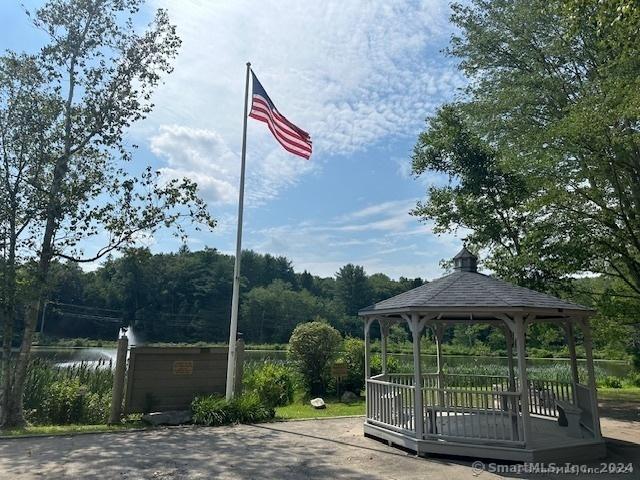 surrounding community with a gazebo and a water view