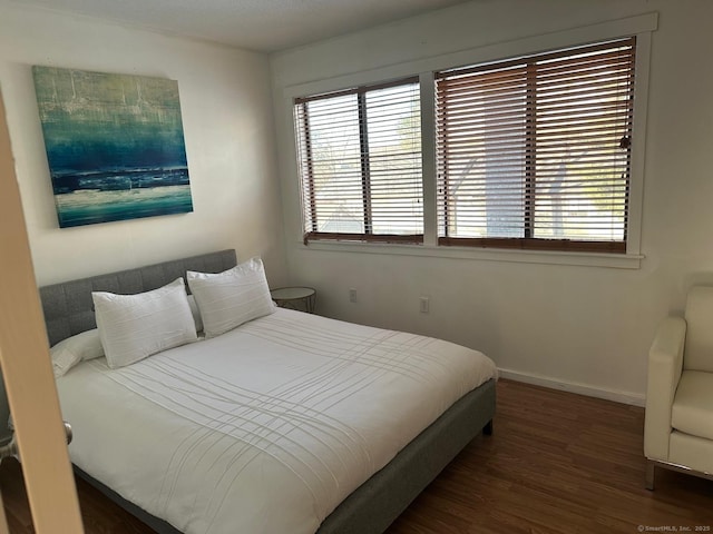 bedroom with dark wood-type flooring