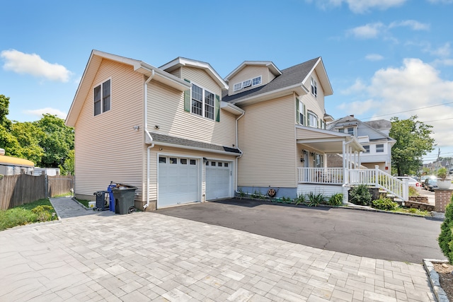 view of front of home with a porch and a garage