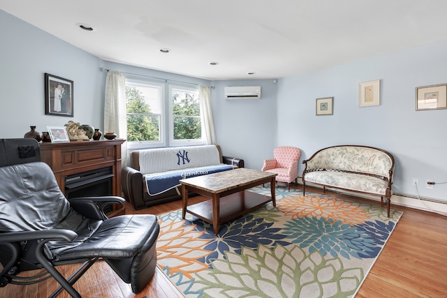 living room featuring a wall mounted air conditioner, a baseboard heating unit, and wood-type flooring