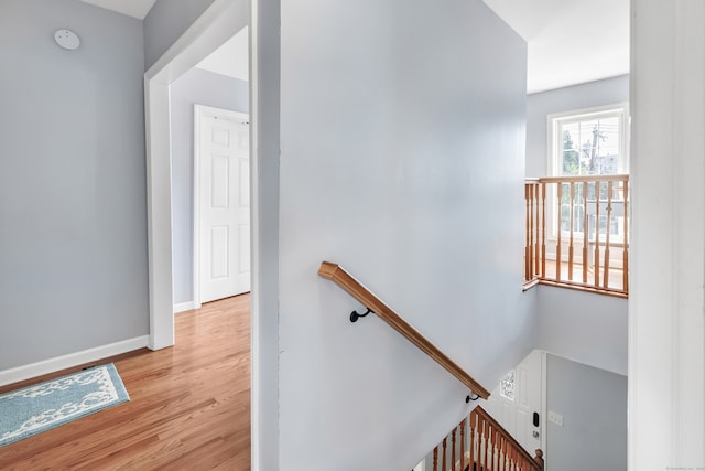 hallway with light hardwood / wood-style floors