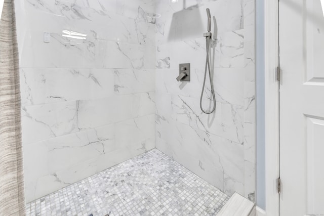 bathroom with a tile shower