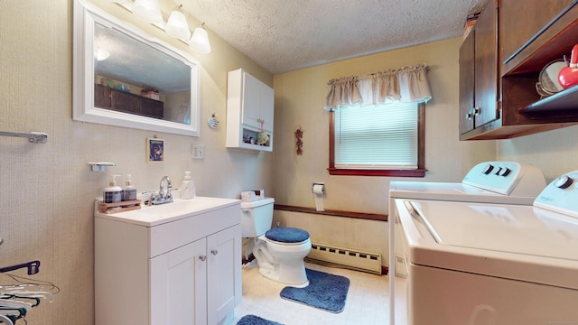 230 Unionville Ave, Plainville, CT 06062 - bathroom featuring baseboard heating, washer and dryer, vanity, toilet, and a textured ceiling
