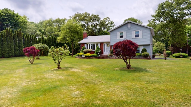 230 Unionville Ave, Plainville, CT 06062 - tri-level home featuring a chimney and a front lawn