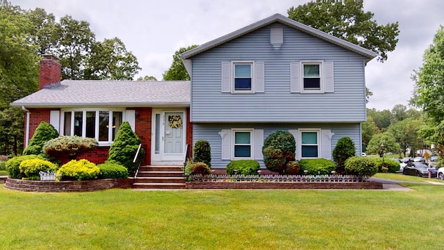 230 Unionville Ave, Plainville, CT 06062 - tri-level home with a front yard, a chimney, and brick siding