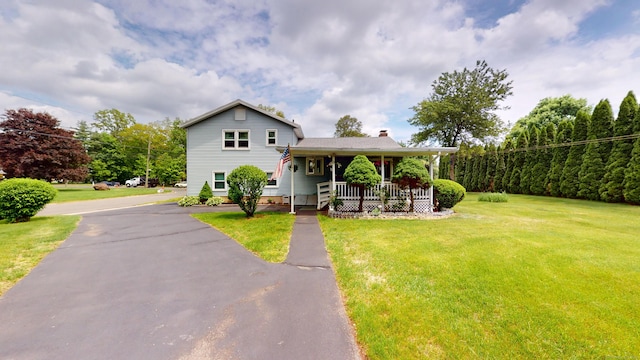 230 Unionville Ave, Plainville, CT 06062 - split level home featuring a chimney, covered porch, and a front lawn