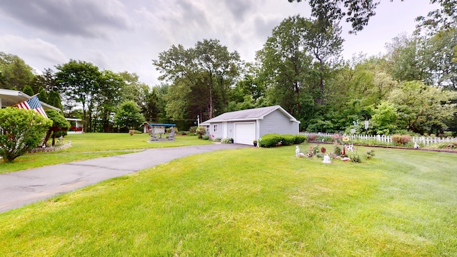 230 Unionville Ave, Plainville, CT 06062 - view of yard featuring an outbuilding, a detached garage, asphalt driveway, and view of scattered trees