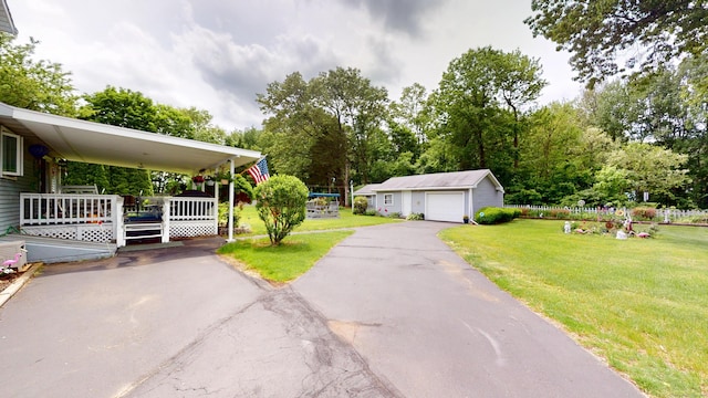 230 Unionville Ave, Plainville, CT 06062 - view of front of property featuring a front yard, an outbuilding, a detached garage, and view of scattered trees