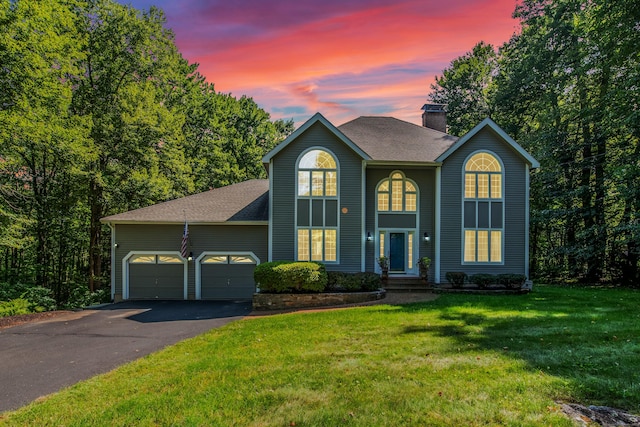 view of property with a yard and a garage