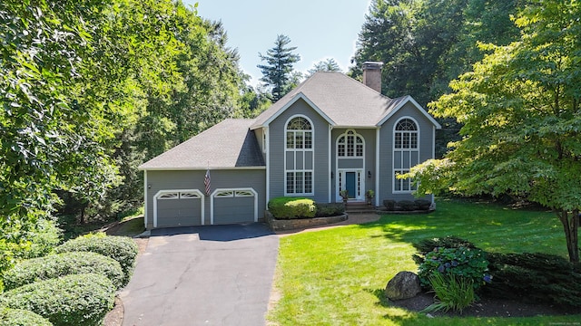 view of front of home featuring a garage and a front lawn