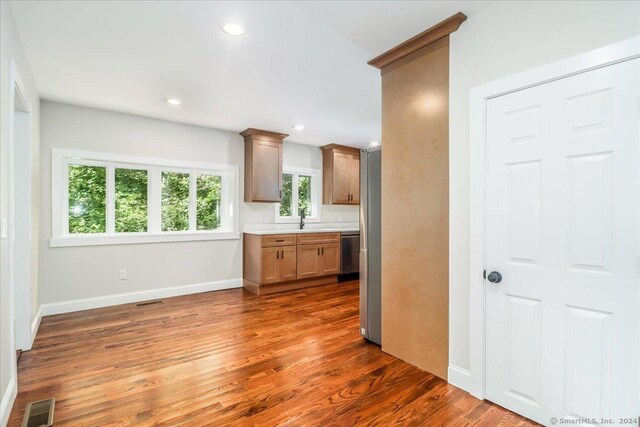 kitchen featuring sink, dark hardwood / wood-style flooring, and dishwasher