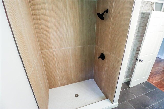 bathroom featuring walk in shower and tile patterned flooring