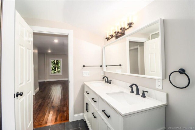 bathroom with hardwood / wood-style floors and dual bowl vanity